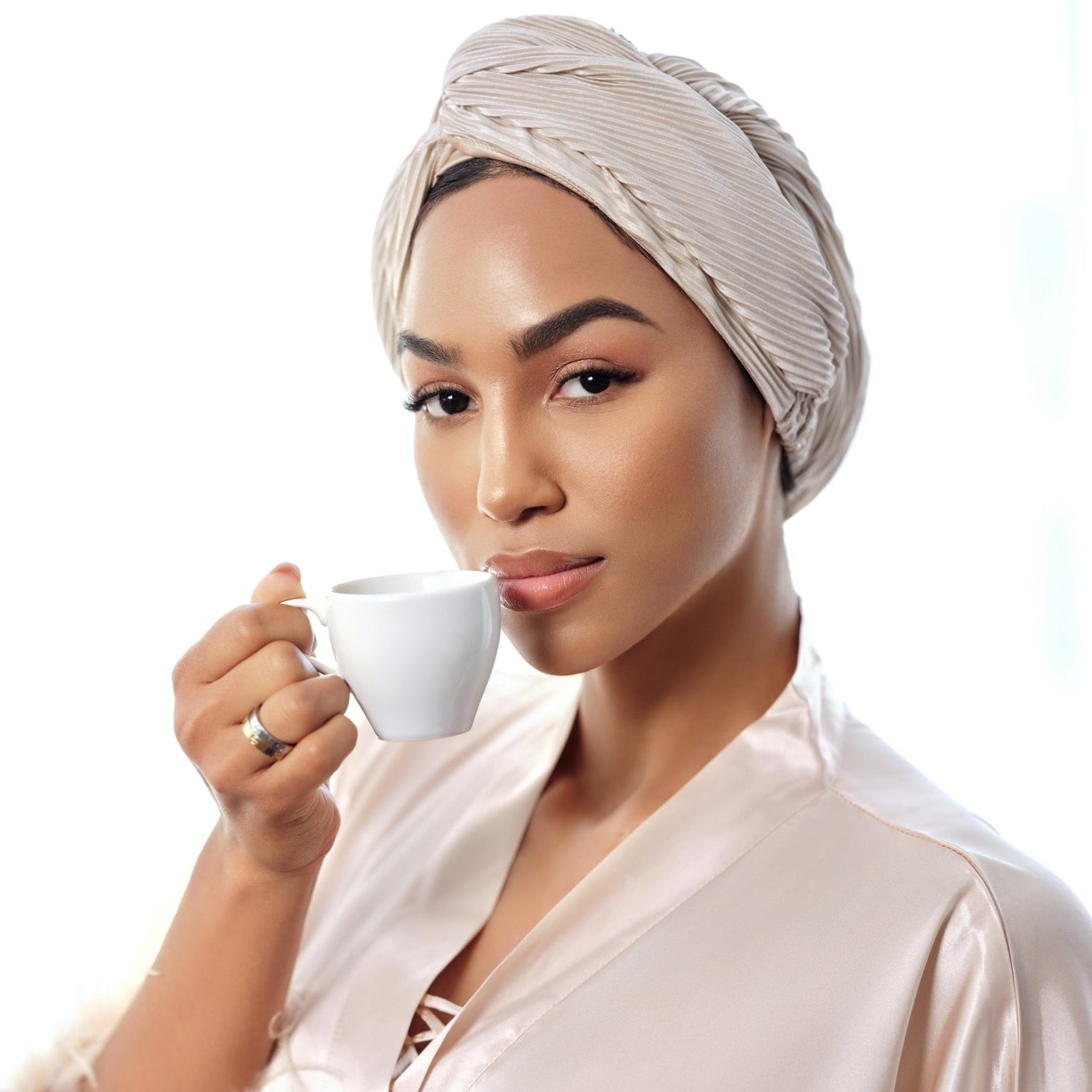 A beautiful coffee drinking girl wearing turban